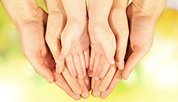 Family hands on bright background